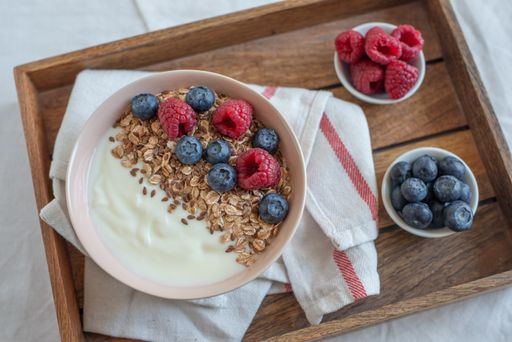 A healthy breakfast with a bowl of granola, yogurt and fresh berries