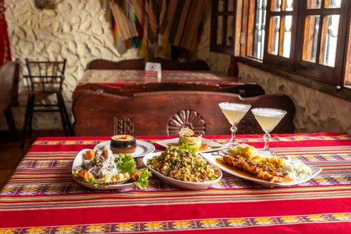 A closeup shot of different dishes with margarita cocktail on a colorful table