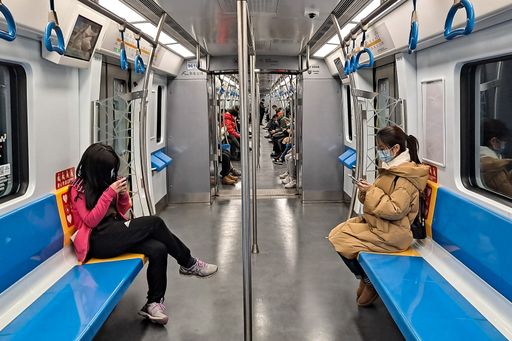 A few passengers with face masks travel in a subway during the coronavirus