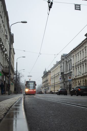 A vertical shot of the red tram on the road. Bratislava, Slovakia.