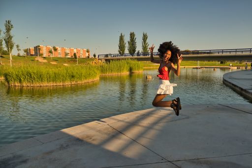A closeup of a beautiful African American woman jumping happily