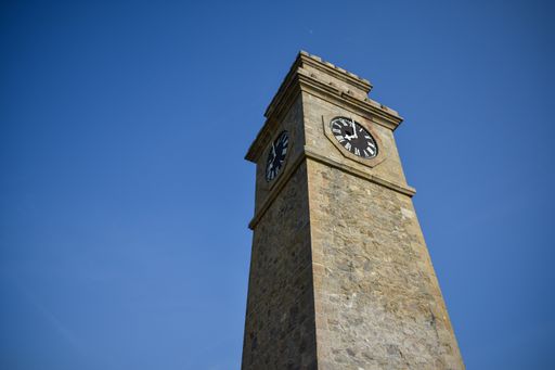 A low angle of a clock tower under the blue sky in Sri Lanka
