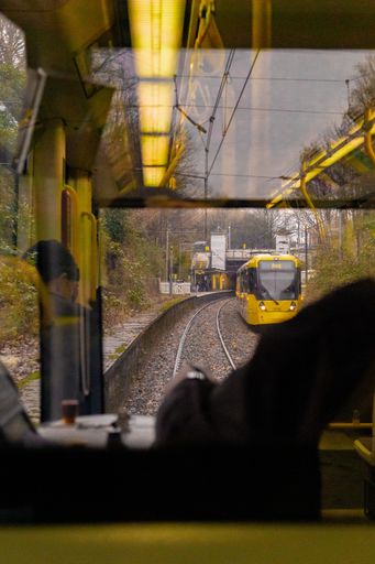 A view of the yellow tram on the railway from inside the tram
