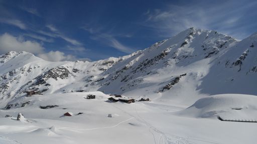 A beautiful shot of snowy mountain peaks under a blue sky