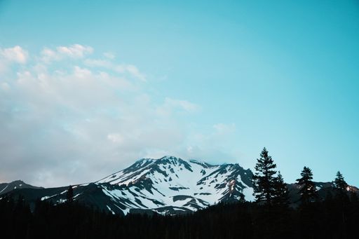 A beautiful shot of rocky snowy mountains under the beautiful blue sky