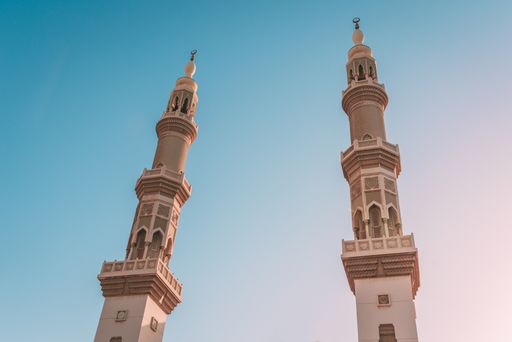 The two towers of Al Maghfirah Mosque in Sharjah, UAE under the clear sky