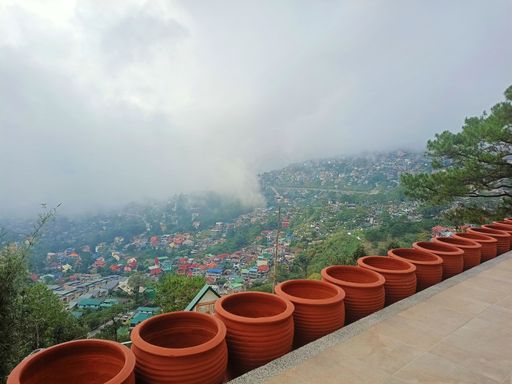 A beautiful view from the top of a building decorated with red pots