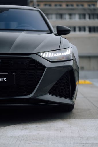 A vertical shot of a silver Audi RS 6 in a parking lot