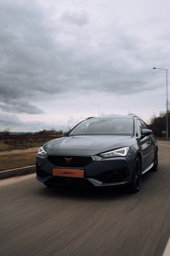 A vertical shot of a SEAT Leon Cupra driving around
