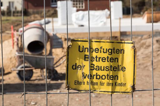 A closeup shot of the German construction sign saying-unauthorized entering, construction site prohibited, parents are responsible for their children