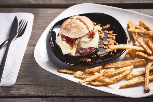 A closeup shot of a tasty burger and fries on a table