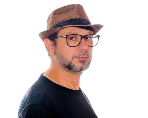 A White bearded man from Brazil wearing eyeglasses and a hat isolated on a white background