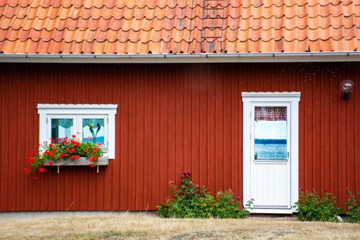 An old house with a white door and window in a village