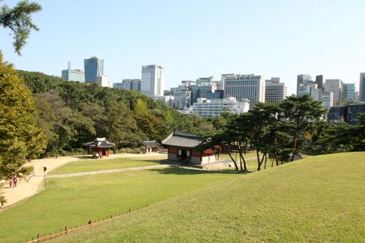 A view of buildings with a park in Korea under the blue sky
