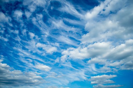 A low angle shot of a blue cloudy sky at daytime - perfect for wallpapers and backgrounds