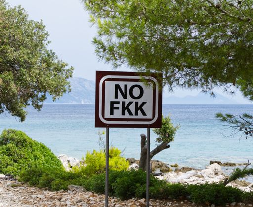 A sign showing No FKK (free body culture) near the lake