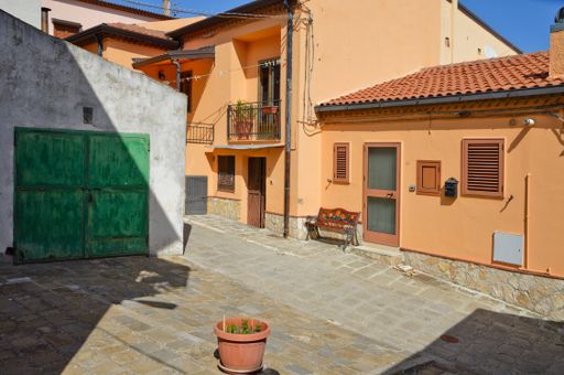 A narrow street between the old village houses in Brindisi Montagna, Basilicata region, Italy