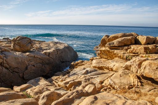 The rocks on the shore of the sea on a sunny day