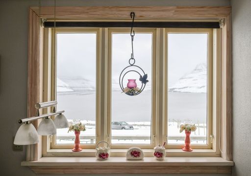 A beautiful interior of a wooden modern decorated window with toys to a sunny view beyond at home
