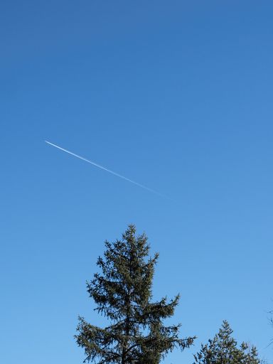A low angle shot of a beautiful blue sky view with traces of plane