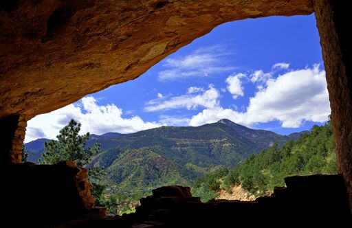 An amazing view of majestic mountains opening from a cave