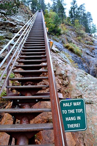 A vertical shot of a wooden staircase in a rocky landscape