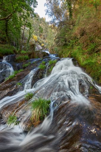 A natural view of a small waterfall formed in the Arenteiro river in Galicia, Spain