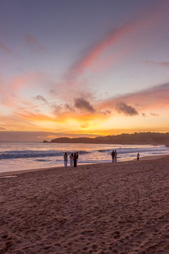 A vertical shot of the sandy beach and the sea in the evening. Vau beach, Portimao, Portugal.
