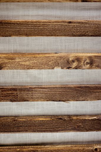 A vertical shot of wooden planks on a gray background
