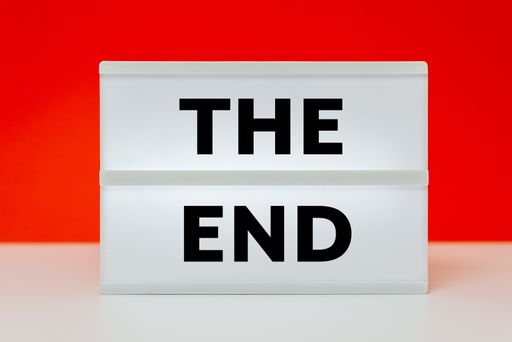 An illustration of the end sign on the white surface in the red background.