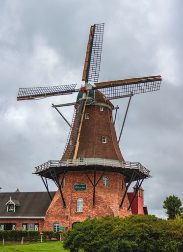 A vertical shot of a mill in Denmark among beautiful nature