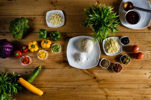 A top shot of many ingredients on a wooden table ready to become a dish.
