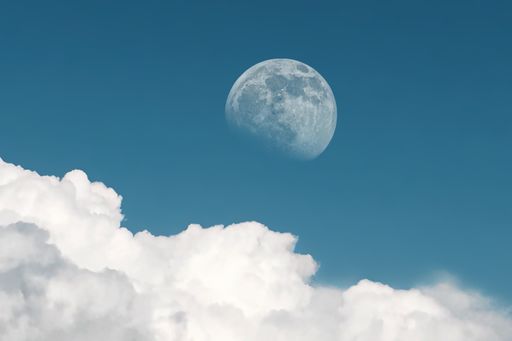 A full moon appears during daytime in late afternoon