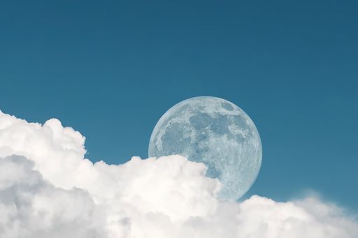 A full moon appears during daytime in late afternoon