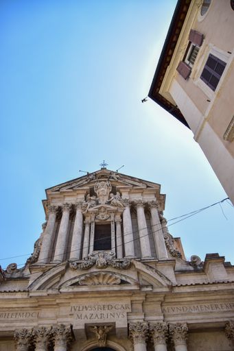 A vertical low angle shot of Trevi Fountain in Rome, Italy under a clear blue sky