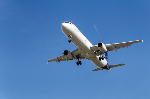 The Lufthansa airline Airbus A321 plane flying over the airport in Barcelona, Spain