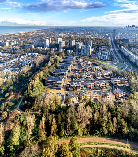 Aerial photo of the Finest of Ockenburg neighborhood  project in The Hague-Kijkduin with a view over the entire city on a misty November morning