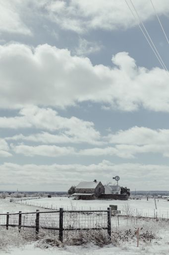 A beautiful shot of a ranch covered in snow in winter
