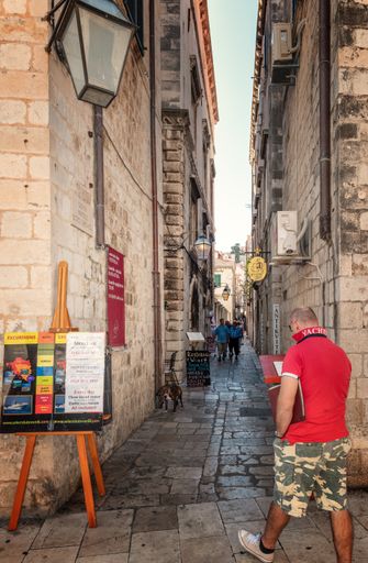 Tourists walking in narrow streets of Kotor, Montenegro