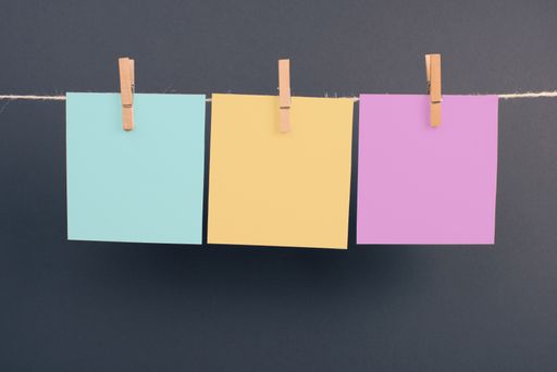 Empty white sheets of paper in a row hanging on a string, copy space for pictures and text, message communication and marketing background