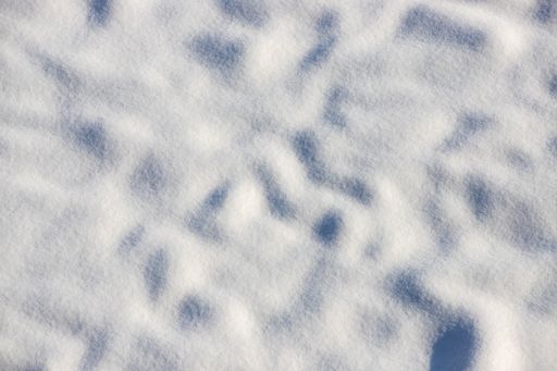 A top view of snow under sunlight