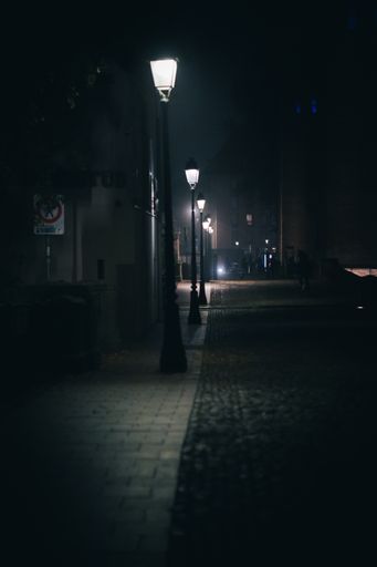 A vertical shot of the alley illuminated by lights in Strasbourg at night