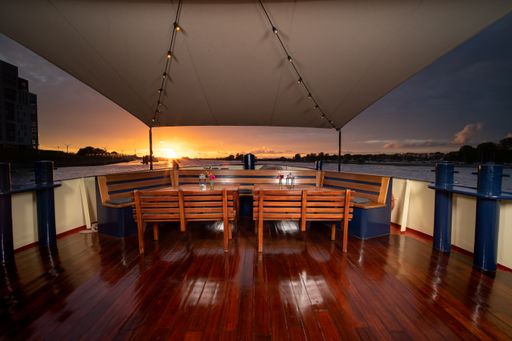 A landscape shot capturing tables taken in a floating restaurant