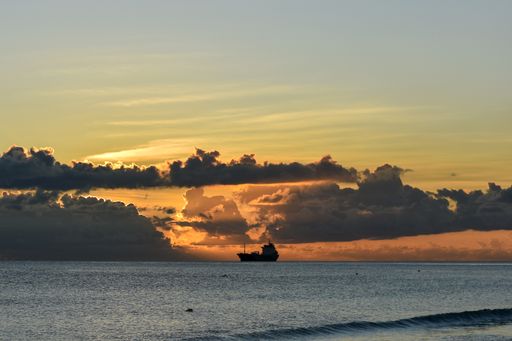 A beautiful view of a ship sailing at sunset