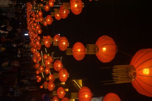 A view of traditional Chinese lanterns hanging in the darkness