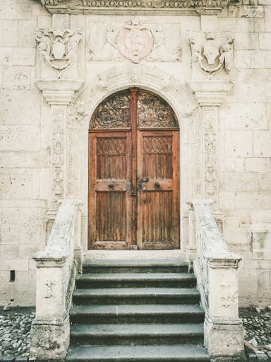A vertical closeup shot of a Saint Michael Roman-Catholic Cathedral entrance door in Romania