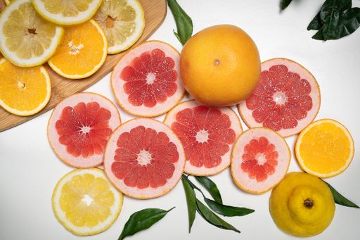 A closeup shot of oranges and lemons on the white background
