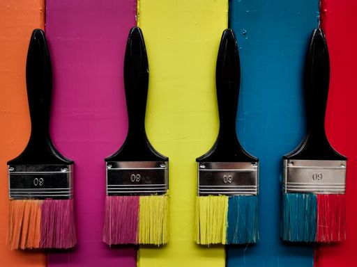 A top view of Colorful paint brushes on colorful background