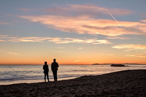 A scenic view of two people enjoying a beautiful sunset in Laguna Beach, California