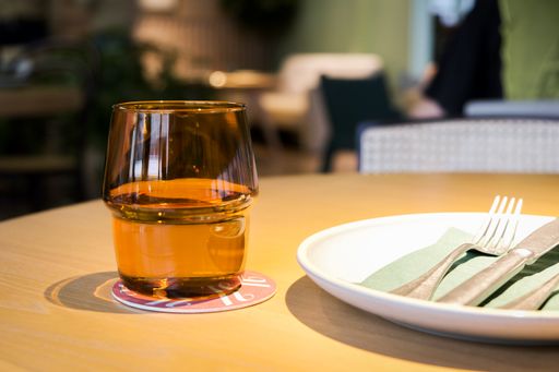 An glass and a plate on a table